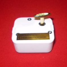 a close up of a white box with a gold plate on it's side