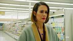 a woman in a grocery store looking at the camera