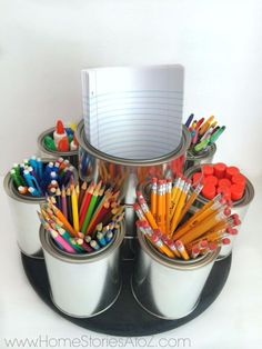 there are many pencils and markers in the cups