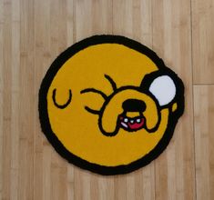 a rug with a cartoon dog on it sitting on a wooden floor in front of a wood floor