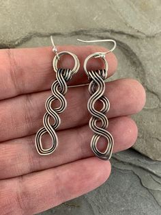 These beautiful Celtic drop earrings are truly unique. They are made completely by hand with fine silver. I was inspired to create these by the many different Celtic braids and knotwork in Irish culture and felt these were a good interpretation with a modern twist. Pleasingly simple yet extraordinary, these earrings can be worn dressed up or down. They are extremely versatile and will compliment any outfit as well as get you compliments whenever you wear them. MATERIALS * Fine Silver * Earring w Silver Dangle Wrap Earrings With Ear Wire, Artisan Dangle Wrap Earrings As Gift, Silver Plated Dangle Wrap Earrings, Silver Hypoallergenic Dangle Wrap Earrings, Bohemian Sterling Silver Wrap Earrings As Gift, Bohemian Sterling Silver Wrap Earrings For Gift, Silver Plated Dangle Wrap Earrings Gift, Handmade Silver Wrap Earrings, Silver Teardrop Wrap Earrings For Gift