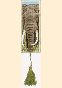 an elephant cross stitch pattern hanging on a wall with a tassel in it's trunk