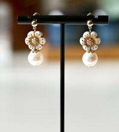 Add a touch of elegance to your wardrobe with these pretty earrings! These elegant fun-style dangle earrings are made with colorful Czech vintagle flower beads and Swarovski pearls. The ear studs are 14k gold plated, ensuring that the earrings are both durable and comfortable to wear. Each pair of these earrings is handcrafted with care and attention to detail, making them a truly unique and special piece of jewelry. They would make a lovely gift for a friend or loved one, or a beautiful additio Elegant Flower Beaded Earrings, White Dangle Pearl Clip-on Earrings, White Dangle Clip-on Pearl Earrings, White Pearl Dangle Clip-on Earrings, Elegant White Flower Shaped Beaded Earrings, Elegant Gold Flower-shaped Beaded Earrings, Elegant Gold Flower Beaded Earrings, Elegant Flower Shaped Beaded Earrings For Gift, Elegant Flower Shaped Beaded Earrings