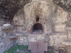 an old stone building with a brick oven