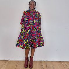 The Confetti dress. Our loose fit colourful dresses made out of non-stretchy African print are perfect for you in case you are looking for a style idea that is versatile, comfortable, and looks fabulous year-round. All materials used to design the dresses are sourced in Kenya.  MEASUREMENT GUIDE:  We recommend asking questions about sizes or you can take your own measurements (at the bust) if unsafe. Since its an A- Line, you only need to ensure that you have the right fit for the bust. Please s Casual Multicolor Printed Shirt Dress, Casual Multicolor Knee-length Shirt Dress, Multicolor Printed Collared Shirt Dress, Casual Multicolor Midi Dress For Dress Down, Casual Multicolor Midi Dress For Dress Down Occasions, Casual Midi Dress With Vibrant Print, Oversized Multicolor Printed Dresses, Multicolor Midi Length Shirt Dress, Casual Multicolor Short Sleeve Shirt Dress