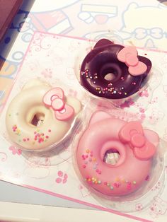 three donuts with hello kitty designs on them