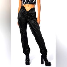 Serve Nothing But Net With The Akira Label Swish Swish High Rise Joggers! These Fresh Athleisure Bottoms Are Made From A Slick, Lightweight Fabrication And Feature A Curved High Rise Waist With An Elastic Back Band, A Skinny Leg Fit, And Cinched Elastic Ankle Hems. Pair This Sculptural Piece With A Crop Top And Chunky Sneakers To Complete Your Look. - 100% Polyester - Hand Wash Cold - 40.5” Waist To Hem - 29” Inseam (Approx. Measured From Size Small) - Model Is Wearing Size Small - Imported Alth Edgy Fitted High Waist Parachute Pants, Edgy Fitted High-waist Parachute Pants, Black Stretch High Waist Parachute Pants, Edgy Black Parachute Pants, Fitted Parachute Pants With Pockets For Night Out, Trendy Black High Waist Parachute Pants, Black High-waisted Parachute Pants For Night Out, Black Parachute Pants For Night Out, Fitted Trendy Parachute Pants For Streetwear