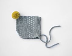 "Alpaca baby bonnet - knitted toddler bonnet - Polka dot hat - Knitted hat children - Pompom infant hat - Children knit hat Sweet polka dot alpaca baby bonnet with contrasting pompom. Warm and lightweight. Knitted in a high quality blend in 20% babyalpaca, 30% merino wool, 50% acryl. The yarn is made in Italy by Alpes Manifattura Filati. Grey with white dots and mustard pompom. This item is made for order, please see my shop announcement for the current production time. If you need a rush order, Handmade Playful Winter Bonnet, Playful Handmade Winter Bonnet, Winter Playful Soft Knit Bonnet, Cute One-size Knitted Bonnet, Playful Warm Bonnet Cap, Cute Knitted Beanie Bonnet, Cute Knitted Bonnet Cap, Playful Knitted Bonnet, One Size, Cute Winter Bonnet As Gift