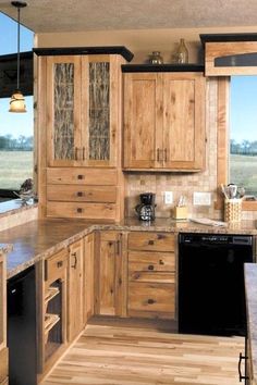 a kitchen with wooden cabinets and black appliances