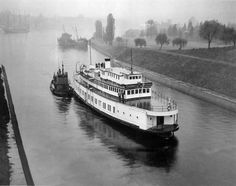 a large white boat floating on top of a river