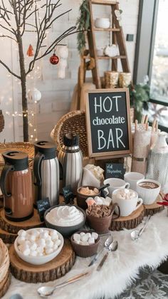 a hot chocolate bar with marshmallows and other desserts on the table