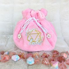 This cherry blossom multi pocket dice bag is made with two shades of pink plush fabric. It is soft to the touch and will keep your dice nice and cozy. The embroidered design on the front features a D20 with cherry blossom branches and flowers being visited by a butterfly. The bag has strong cord drawstrings accented with cherry blossom charms at the ends.  Inner bag space is about 9 x 4.5 inches, plenty of room for several sets of dice, there are 6 inner pockets that will hold 3 to 4 standard di Cute Handmade Pink Pouch, Pink Gift Bag Pouch, Handmade Pink Pouch For Gifts, Pink Gift Pouch, Pink Embroidered Pouch For Gift, Embroidered Pink Pouch For Gift, Embroidered Pink Pouch For Gifts, Embroidered Pink Pouch As Gift, Dice Storage