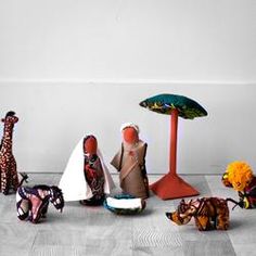 an assortment of stuffed animals sitting next to each other on the floor in front of a white wall