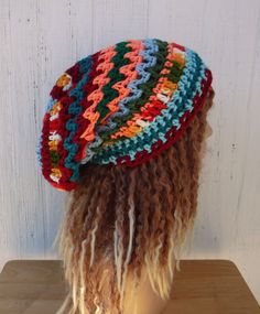 "OOAK handmade crochet beanie, with random colored zigzagging stripes. \"Eclectic Mix\" contains blues, teal, green and variegated yarns. The length and width is suitable for dreadlocks (short to medium). Width at brim 20\", stretches to 25\", cinches smaller with drawstring Length from crown to rim 10,5\"  Widest point across 11\" All hypo-allergic acrylic yarn.  I suggest hand-washing and flat-drying, care suggestions come in each package." Casual Beanie For Festivals, Multicolor Handmade Slouchy Hats, Handmade Multicolor Slouchy Hat, Bohemian Slouchy Crochet Beanie, Slouchy Crochet Bohemian Beanie, Slouchy Bohemian Crochet Beanie, Bohemian Winter Beanie, Bohemian Beanie One Size Fits All, Bohemian Beanie One Size