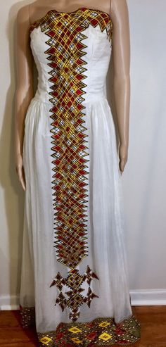 -Custom-made Ethiopian & Eritrean Dress. -This order takes approximately 4-5 weeks to make and deliver. -We will contact you about measurements instructions upon purchase. -You are allowed to change the colors and design. - Ethiopian dress - Eritrean dress - Habesha Kemis - Ethiopian Wedding - Eritrean Wedding - Habesha wedding - Zuria - Eritrean Traditional Dress -Ethiopian Traditional Dress -Ethiopian kids clothing -Eritrean kids clothing -Ethiopian men clothing -Eritrean men clothing White Dresses With Weaving Work For Traditional Ceremonies, White Folk Dress With Weaving Work, Fitted Traditional Dress With Embroidered Border, Traditional Fitted Dress With Embroidered Border, Festival Dresses With Embroidered Border And Fitted Stretch, White Dresses With Embroidered Border And Traditional Drape, Fitted Floor-length Dresses With Motifs, Traditional Fitted Dress With Motifs, Fitted Habesha Kemis With Traditional Patterns For Ceremonies