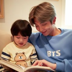 a woman sitting next to a child reading a book