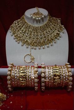 Bridal Ahemdabadi Kundan set in tinted kundan stones, with gold plating. This is a bridal set that comes with earrings and tika.  Bangles and Nath are sold separately. Please contact us for a detailed video of the set Hand Set Kundan Tikka For Festivals, Indian Bridal Choker, Bridal Jewelery, Bridal Choker, Kundan Jewelry, Bridal Bangles, Indian Wedding Jewelry, Kew Gardens, Jewelry Indian