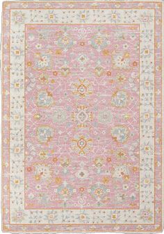 a pink, yellow and white rug with an ornate design on the bottom half of it