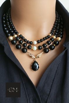 A true statement piece that exudes elegance and sophistication, our elegant Onyx Multi-Strand Black Beaded Necklace consists of numerous sparkling onyx beads and zircon bird wing pendants, carefully handcrafted and meticulously assembled to create a stunning visual effect. Shiny black onyx beads, known for their grounding and protective properties, add a mystical touch to this elegant boho accessory. Luxury Beaded Necklaces For Party, Elegant Black Beaded Necklaces, Elegant Black Beaded Necklaces For Evening, Elegant Black Beaded Necklace For Evening, Elegant Black Beaded Necklace For Evenings, Elegant Black Necklace For Celebration, Elegant Black Beaded Necklaces For Celebration, Elegant Black Beaded Necklace For Celebration, Black Beaded Necklace