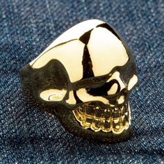 METALIC 14K YELLOW GOLD OVER SOLID BRASS SKULL RING ~NEW  Solid brass with 14k yellow gold plating  Ring weight: 20 grams    Ring face measures: 1" x 1 1/4"   A dash of luxury on every single ride, embrace the decadence of our Metalic Yellow Gold Brass Skull Ring. A combination of gothic design and rich colour, this piece is entirely custom made and truly one-of-a-kind.  The polished skull head sits complete with clenched jaw and deep eye-sockets that glare out at every passer-by. It is only the Luxury Skull Ring With Polished Finish, Luxury Silver Skull Ring With Polished Finish, Luxury Gold Skull Jewelry, Skeleton Rings Gold, Luxury Gold Sterling Silver Skull Ring, Luxury Gold Skull Ring Gift, Luxury Unique Gold Skull Ring, Luxury Gold Skull Ring In Sterling Silver, Luxury Gold Men's Skull Ring