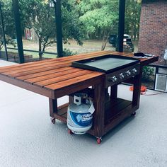 an outdoor bbq table with a grill on it