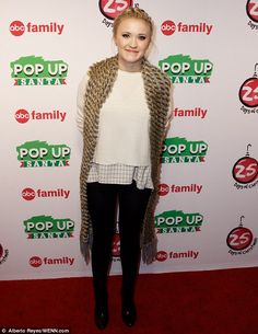 a woman standing on top of a red carpet