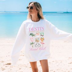 Embrace the coastal charm with our Destin, Florida oversized sweatshirt! Showcasing the essence of seaside living, this shirt exudes beachy vibes and local pride. Perfect for strolling along 30a or soaking up the sun, it gives tortured poet respecting the locals. Featuring a bold set of graphics, the design with a playful water gator captures the essence of ocean-inspired style. Crafted with comfort in mind, this tee is ideal for casual outings or laid-back days by the shore. Whether you're a re Trendy Sweatshirt For Beach In Spring, Trendy Spring Beach Sweatshirt, Spring Beach Cotton Sweatshirt, Spring Beach Long Sleeve Sweatshirt, Oversized Spring Beach Sweatshirt, Oversized Sweatshirt For Beach In Spring, Trendy Cotton Sweatshirt For Beach, Oversized Sweatshirt For Spring Beach Outings, Spring Long Sleeve Sweatshirt For Beach