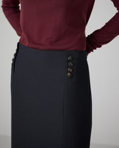 Sleek tube skirt in a sculptural wool viscose with monogram horn button details at the waist. Chic Formal Pencil Skirt With Button Closure, Chic Buttoned Pencil Skirt For Work, Chic Workwear Pencil Skirt With Buttons, Chic Pencil Skirt With Buttons For Workwear, Elegant Skirt With Side Buttons, Elegant Black Pencil Skirt With Buttons, Elegant Office Skirt With Side Buttons, Elegant Wool Bottoms With Button Closure, Elegant Fitted Wool Pencil Skirt