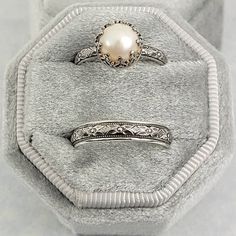 Timeless and classic, this vintage-inspired pearl engagement ring and floral wedding band set are reminiscent of the Edwardian era when fine metalwork was designed with intricate details and delicate settings that were fashioned to resemble the look of fine lace.Each ring is handmade specifically for you in the size you choose using recycled sterling silver. The Edwardian-inspired pearl engagement ring holds a luminous 8-8.5mm cultured creamy white freshwater pearl in a filigree heart-crown sett Pearl Wedding Set Ring, Silver Band Engagement Ring Unique, Vintage Wedding Rings 1920s Silver, Goth Wedding Rings Matching, Pearl Stone Ring, Silver Antique Rings, Vintage Wedding Rings Pearl, Silver Vintage Ring, Vintage Bridal Set