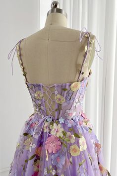 Embroidery Floral Illusion Corset Top? Bust and Skirt with full lining. 100% Polyester 100% Recycled polyester lining Concealed zip at center back Imported Lavender Floral Applique Dress For Spring, Lavender Fitted Organza Dress, Fitted Lavender Organza Dress, Fitted Purple Dress With Floral Applique, Embroidered Lavender Dress For Spring, Lavender Embroidered Spring Dress, Purple Floral Embroidery Wedding Dress, Spring Lavender Embroidered Dress, Spring Embroidered Lavender Dress