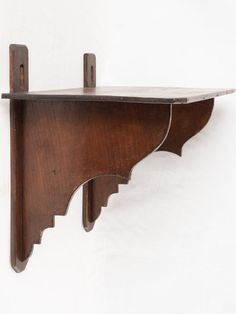 a wooden shelf with two brackets attached to it