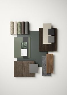 an assortment of different materials are arranged on a white wall with grey and brown accents