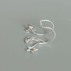 Sterling silver ear cuff and wrap earring.Comes with a crescent moon and stars. This listing is for ONE PAIR Size: 15 x 19 mm Stars: 5x 5mm Crescent moon: 6 x 5mm Weight: 0.90gm These earrings are made of real 925 hypoallergenic sterling silver. All my pieces are sent in a gift box. I can include a personal message from you if needed You are welcome to contact me at... bhavnakwintra1956@gmail.com For more beautiful pieces from my shop, please browse 👇 TOE RINGS: https://www.etsy.com/your/shops/ Adjustable Silver Trendy Ear Cuff, Adjustable Silver Ear Cuff Trendy Style, Silver Star-shaped Pierced Cartilage Earrings, Silver Star-shaped Cartilage Earrings With Pierced Design, Trendy Silver Pierced Ear Cuff, Silver Star-shaped Ear Cuff As Gift, Silver Star Shaped Ear Cuff As Gift, Silver Star-shaped Ear Cuff For Gift, Silver Star Shaped Ear Cuff Gift