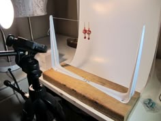 a photo studio setup up for photography with lighting and accessories on the table next to it