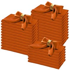 two stacks of orange napkins with bows on them