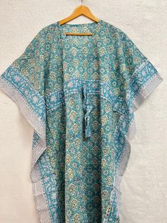 This Beautiful Hand Block Print Caftan or can be called as Tunic is made with super fine quality cotton and designs have been crafted by Hand Printed Usage - Tunic, Gown, Maxi, Bikini Cover up, Beach Wear, Caftan, Party Wear Top. Fabric - Organic Cotton Color - Light Blue Pattern - Floral Print Size - One Plus Size, can fit Upto 4XL Bust Size - Free Size ( Drawstring ) Long Caftan Length - 50" Inches (Approx ) * It has Adjustable Drawstring Waist. * V Shape Neck Which is 7" Inches Deep. * Very c Traditional Printed Kimono For Beach Cover-up, Green Tunic Kaftan For Festivals, Bohemian Block Print Kimono For Summer, Bohemian Block Print Summer Kimono, Green Free Size Festival Kaftan, Traditional Printed Kimono For Beach, Bohemian Style Long Green Kurta, Green Long Bohemian Kurta, Traditional Festive Kimono For Beach