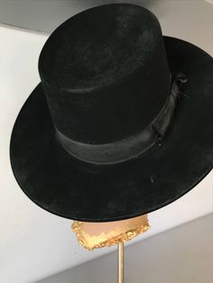 "Hard structure black felt hat. Seems to be an early hat, maybe as early as the 1930's. In good vintage condition. Measurements are: Circumference21\" Dome4\" Brim3\" Feel free to convo me with any further questions. Thank you for your interest." Vintage Wide Brim Top Hat For Church, Vintage Flat Brim Costume Hat For Formal Occasions, Classic Black Wide Brim Costume Hat, Vintage Formal Flat Brim Costume Hat, Vintage Wide Brim Felt Hat For Evening, Vintage High Crown Hat For Formal Occasions, Vintage High Crown Costume Hats For Formal Occasions, Vintage High Crown Fedora For Kentucky Derby, Vintage Black Top Hat For Formal Occasions