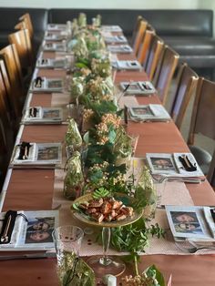 a long table is set up with plates and place settings