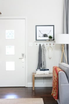 a living room filled with furniture and a white door