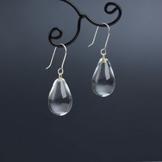 "These Small clear teardrop earrings are made of glass in lampwork technique. The earrings hooks are sterling silver and are hypoallergenic. These unique and beautiful earrings are like water drops frozen in glass! They are simple and elegant, very lightweight and comfortable to wear, perfect for everyday wear and for special occasions. 💕 You will definitely receive lots of compliments on your new earrings, everybody loves them, and you'll love them too! Dimensions: total length about 1 1/8\" i Nickel-free Glass Drop Jewelry, Elegant Glass Drop Jewelry, Elegant Drop Glass Jewelry, Elegant Drop-shaped Glass Jewelry, Modern Glass Teardrop Earrings, Minimalist Teardrop Glass Jewelry, Glass Drop Earrings With Matching Set, Nickel-free Teardrop Glass Jewelry, Nickel-free Glass Teardrop Jewelry