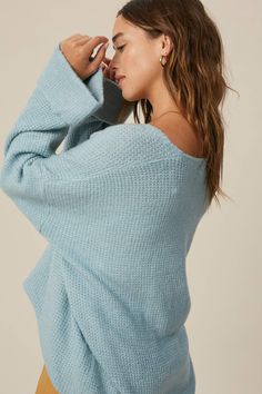 So chic and effortless, this slouchy, oversized tunic-style sweater features a v-neckline and dropped wide sleeves for added shape. -Available in Stone & Misty Blue -Waffle textured -V-neck -Oversized fit -Soft touch eyelash two tone yarn -Long sleeve with folded cuffs -Side slits -Ribbed on hem -Content: 74% Acrylic 22% Polyester 4% Lycra -Hand was cold/Line dry -Imported -Model is 5 8" 32-24-34 and wearing a size Small Oversized V-neck Sweater For Layering, Oversized Tops With Soft Texture, Oversized V-neck Sweater For Spring, Chic Batwing Sleeve Sweater For Loungewear, V-neck Knit Top For Fall Loungewear, V-neck Sweater For Loungewear, Trendy V-neck Sweater For Loungewear, Soft Texture V-neck Tops For Fall, Oversized V-neck Knit Top For Fall