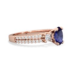 a rose gold ring with an oval blue sapphire and diamonds