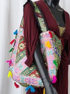 Patchwork, embroidery and sequins women's tote bag. A colourful ethnic shoulder bag from India for women. Unique, classy day or evening hand bag. Take patches of colourful cloth. Add interesting embroidery of sequins and stones and beads. Add some more colourful stitches with contrasting colour thread. Mix and match the patches and hand stitch them with a colourful beading. Add handles. Voila! You have a tote bag that is so unique that there just cannot be another one such, anywhere in the unive Multicolor Rectangular Bag With Zari Work, Embroidered Shoulder Bag For Festivals, Festive Rectangular Shoulder Bag With Mirror Work, Festive Multicolor Embroidered Shoulder Bag, Festive Multicolor Embroidery Shoulder Bag, Multicolor Embroidery Bag With Zari Work For Festivals, Festival Multicolor Embroidered Hobo Bag, Multicolor Embroidery Zari Work Bag For Festivals, Everyday Shoulder Bag With Mirror Work