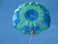 a person is parasailing in the air on a clear day with blue skies