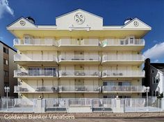 an apartment building with balconies on the second floor