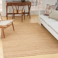 a living room filled with furniture and a rug