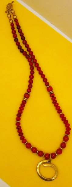 Beautiful Large 10-12 mm Red Coral Beads with Boho Brass Pendant. Matte Brass Accents throughout the necklace accentuate the Pendant nicely. Red 8mm Beads Jewelry For Meditation, Festive 8mm Round Bead Necklace, Red Bohemian Jewelry With 8mm Beads, Red Wooden Beaded Necklaces, Bohemian Red Jewelry With 8mm Beads, Round Wooden Beads Necklaces For Jewelry Making, Red Wooden Beaded Necklace, Wooden Beads Necklaces For Jewelry Making, Bohemian Single Strand Round Beads