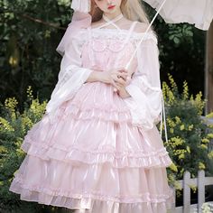 a woman in a pink dress holding an umbrella