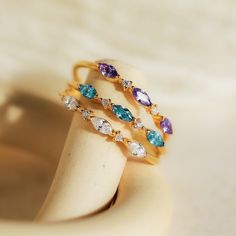 M A R Q U I S E ∙ B I R T H S T O N E ∙ R I N G  Your ultimate stacking ring has arrived! Our Triple Marquise Birthstone Ring allows you to customize to the stone you want. With delicate CZ Diamond gemstones in between each marquise birthstone, this ring shines with even more sparkle. * Material: High Quality Solid 925 Sterling Silver  * Finish: Sterling Silver ∙ 18K Gold ∙ Rose Gold  * Featuring a ~1mm Dainty Ring Band with three ~3.5 x 2mm Marquise Gemstones and ~1mm Round CZ Diamond Stones. ♡ Rock Of Love, Initial Tag Necklace, Birthstone Ring Mothers, Dainty Initial Necklace, Stacker Rings, Marquise Ring, Mother Rings, Anniversary Jewelry, Jewelry Lookbook