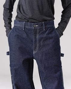 The Recycled Cotton Denim Wide Pants are heavy-weight denim utility pants. The pants feature slanted pockets at the waist, open-top pockets on the back, tool pockets and loops at the thigh on both sides, elastic shirring at the waist, and belt loops. The material is a 12.6oz recycled denim with reinforced stitching. Elastic Shirring, Utility Pants, Recycled Denim, Wide Pants, Open Top, Recycled Cotton, Heavy Weight, Recycling, Stitching